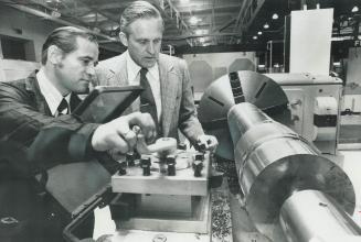 Giant Russian lathe gets close scrutiny from Al Mundy (right) of the Canadian Machine Tool Distributors' Association