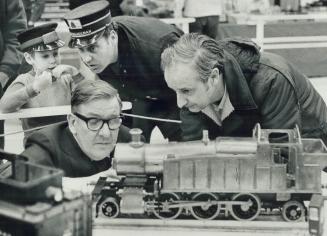Model railroaders show their work, Harry Hawkins (left) and Alan Grigg study Hawkins-built locomotive at the annual hobby show staged by the Lakeshore(...)