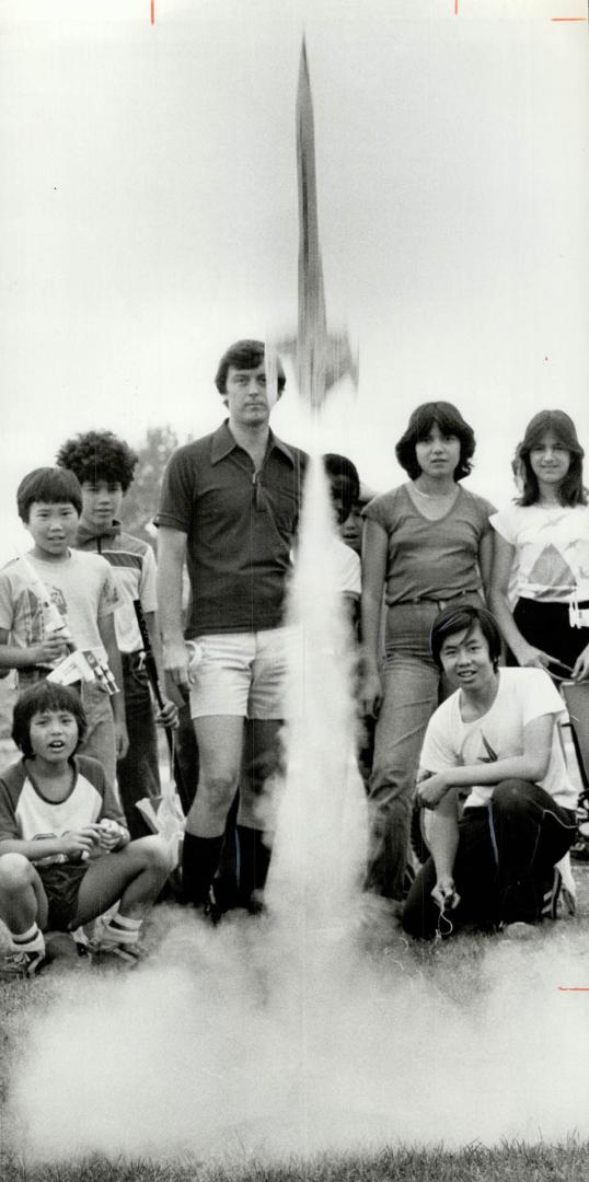Blast off a success: Rocketry teacher Paul Stevens and his students stand back as the Yeung brothers' rocket takes off