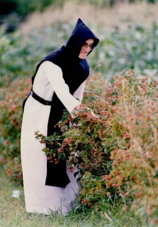 Above, Father Guy Trudel tends 'he garden, he also looks after the monastery's novices