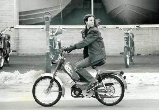 A moped (that's mo' for motor, ped for pedal) is demonstrated by Leslie Warren, 14