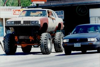 Mad max meets bigfoot: Trenton's Mike Hardy rides high in his Oldsmobile Cutlass mounted on a Chevy Blazer chassis