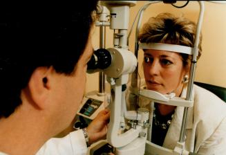 Looking good: Dr. Raymond Stein of the Bochner Eye Institute checks on Kim Cain's intra-corneal ring, which lets her see her alarm clock without glasses