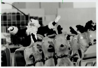 Children bundled up in snowsuits, tuques and mittens, left, against the nip in the air is a sure sign Santa, right, can't be far away - 46 days from t(...)