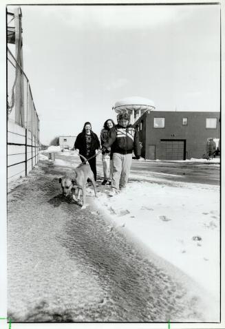 Factory spill: Kathy Hammond, 21, and her brother Rob, 13, with friend Skye McKinnon, 16, centre, walk near water and snow made red from iron oxide dust