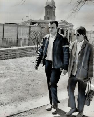 After 4 days as hostage of rebellious convicts at Kingston Penitentiary, prison guard Kerry Bushell, 25, strolls hand-in-hand with his wife down King (...)