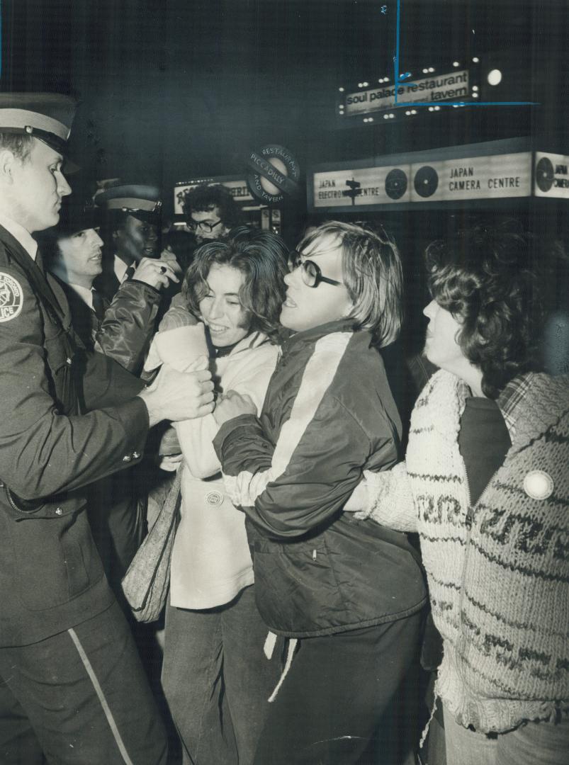Cinema storm, Metro police grapple with women trying to invade Cinema 2000 on Yonge St