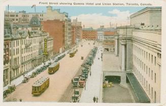 Colorized photograph of a busy downtown street with cars and street cars.