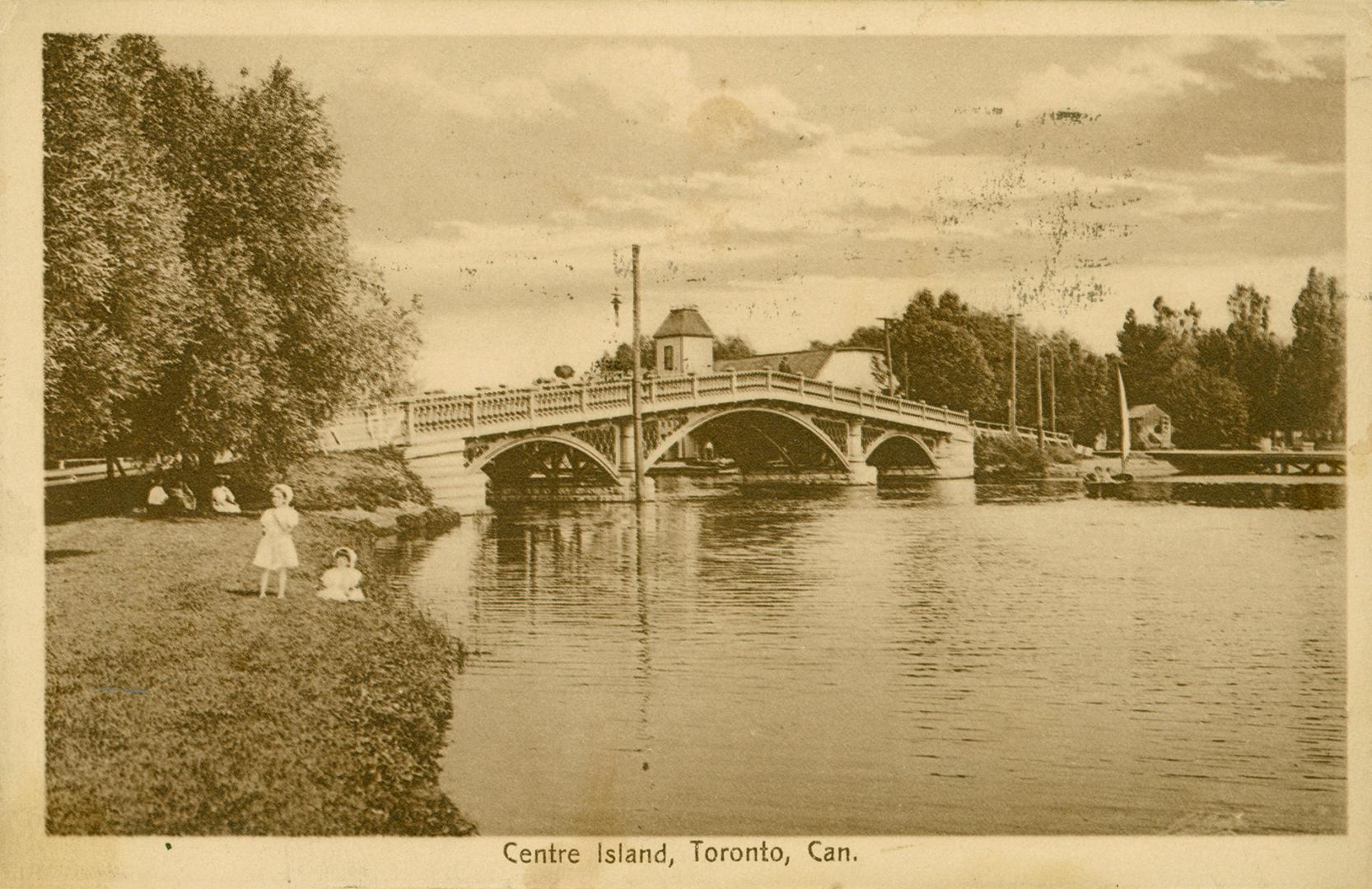 Shows a footbridge over a lagoon.