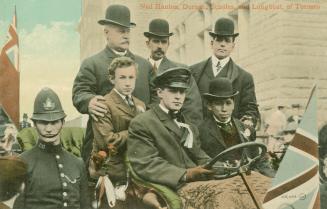 Six men riding in an open air car in front of Toronto City Hall.