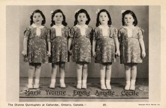 Black and white picture of five identical little girls in matching skirts and blouses.