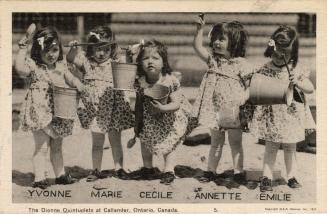 Black and white picture of five identical little girls wearing floral dresses and carrying shov ...