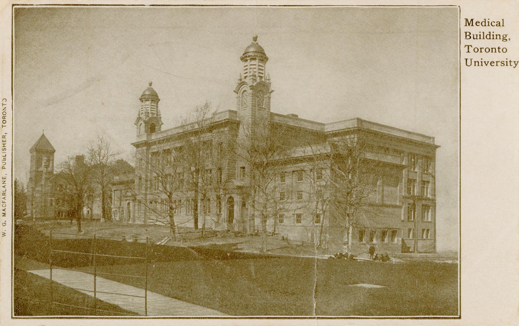 Black and white picture of a three story building with two towers.