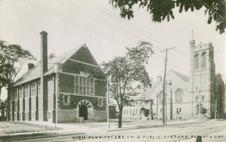 Black and white photograph of two story library and a church.