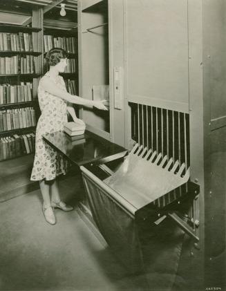 Woman operating a book conveyer. 