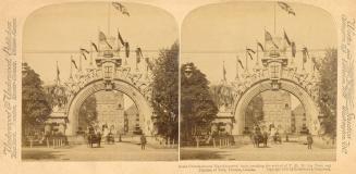 Pictures show a huge archway in front of the Ontario Legislative building with horse drawn vehi ...