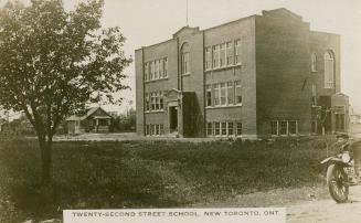 Black and white photograph of a two story, square school.