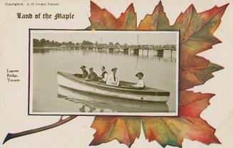 Picture of five people in a boat in a lagoon with a long wooden bridge in the background set in ...
