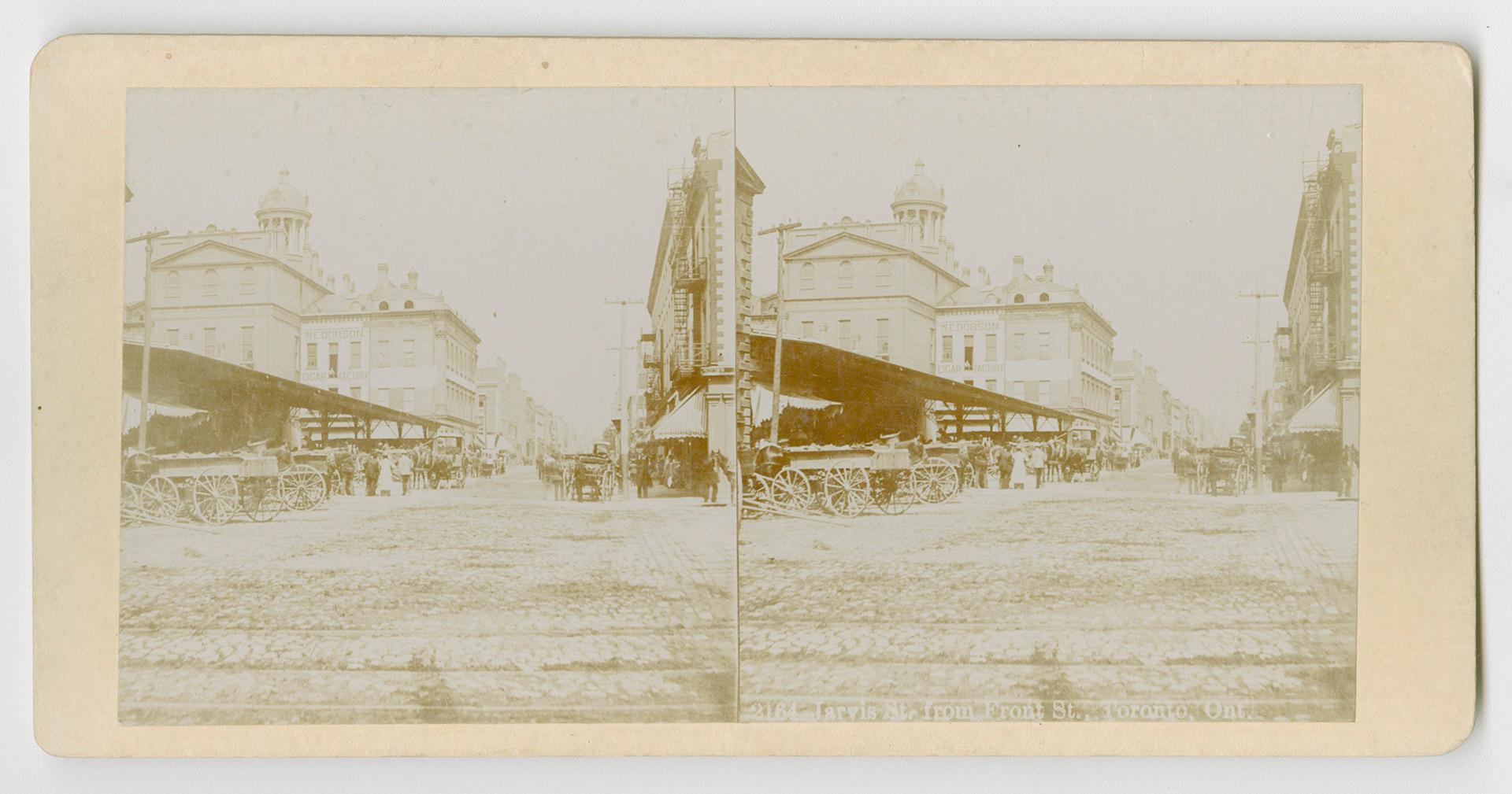 Pictures show covered market stalls with large city buildings behind them.