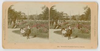 Pictures show two children standing on a path in front of very formal gardens.