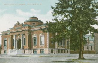 Picture of large public library with front pillars and dome on the roof and large tree to the r ...