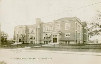 Black and white photograph of a three story collegiate building. 