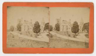 Pictures show a huge collegiate gothic style building looking towards the west.