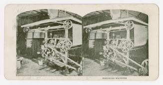 Two photographs of a large piece of machinery located within a room, with belts wrapped around  ...
