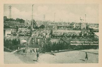 Distant view of large swimming pool and crowds of swimmers with beach and stairs to pool in for ...