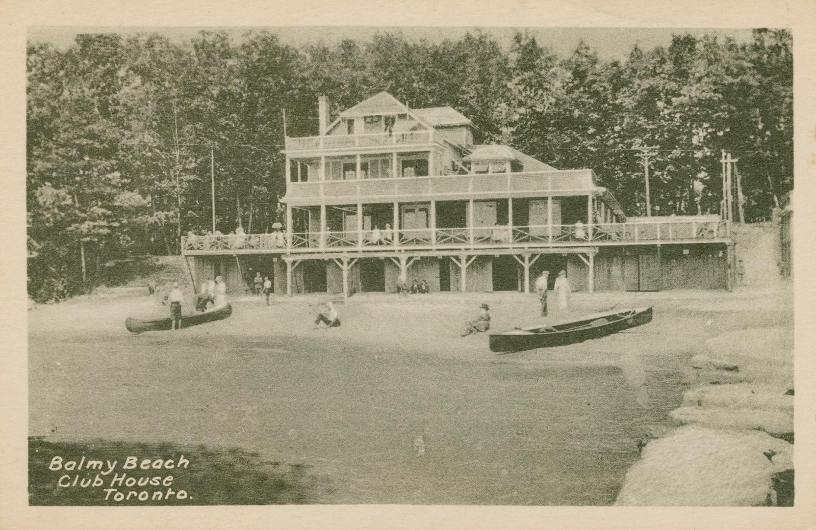 Black and white picture of a four story wooden building on the edge of a beach.