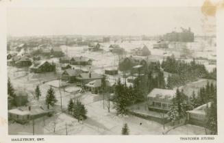 Black and white aerial picture of homes in winter in a small town.