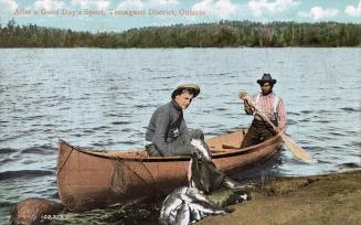 Colorized photograph of two men relaxing in their canoe at a shoreline with a huge catch of fis ...
