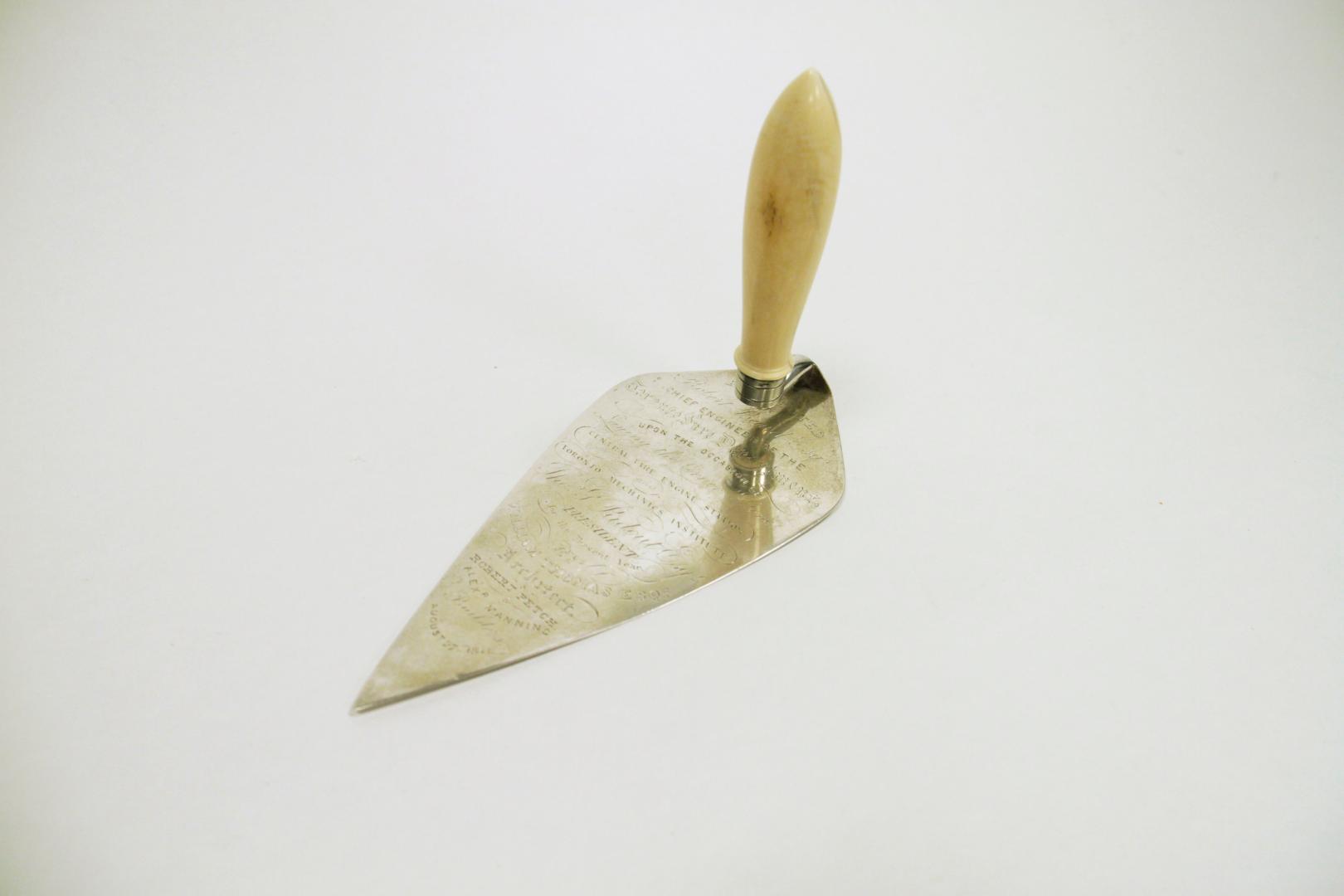 Metal trowel with wooden handle.