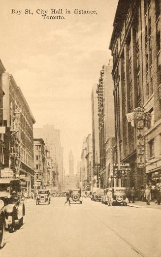 Sepia toned picture of a busy city street with multi-story building on either side of it; autom ...