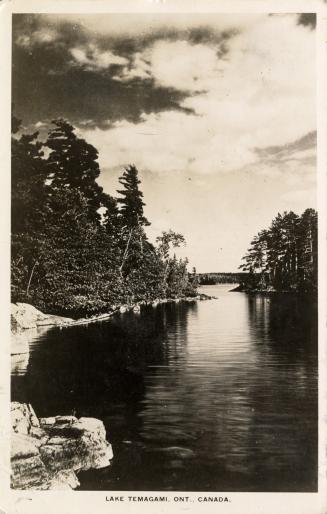 Black and white photograph of a lake in the wilderness. 