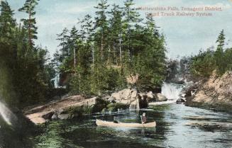 Colorized photograph of a two men in a canoe on a river in the wilderness. 