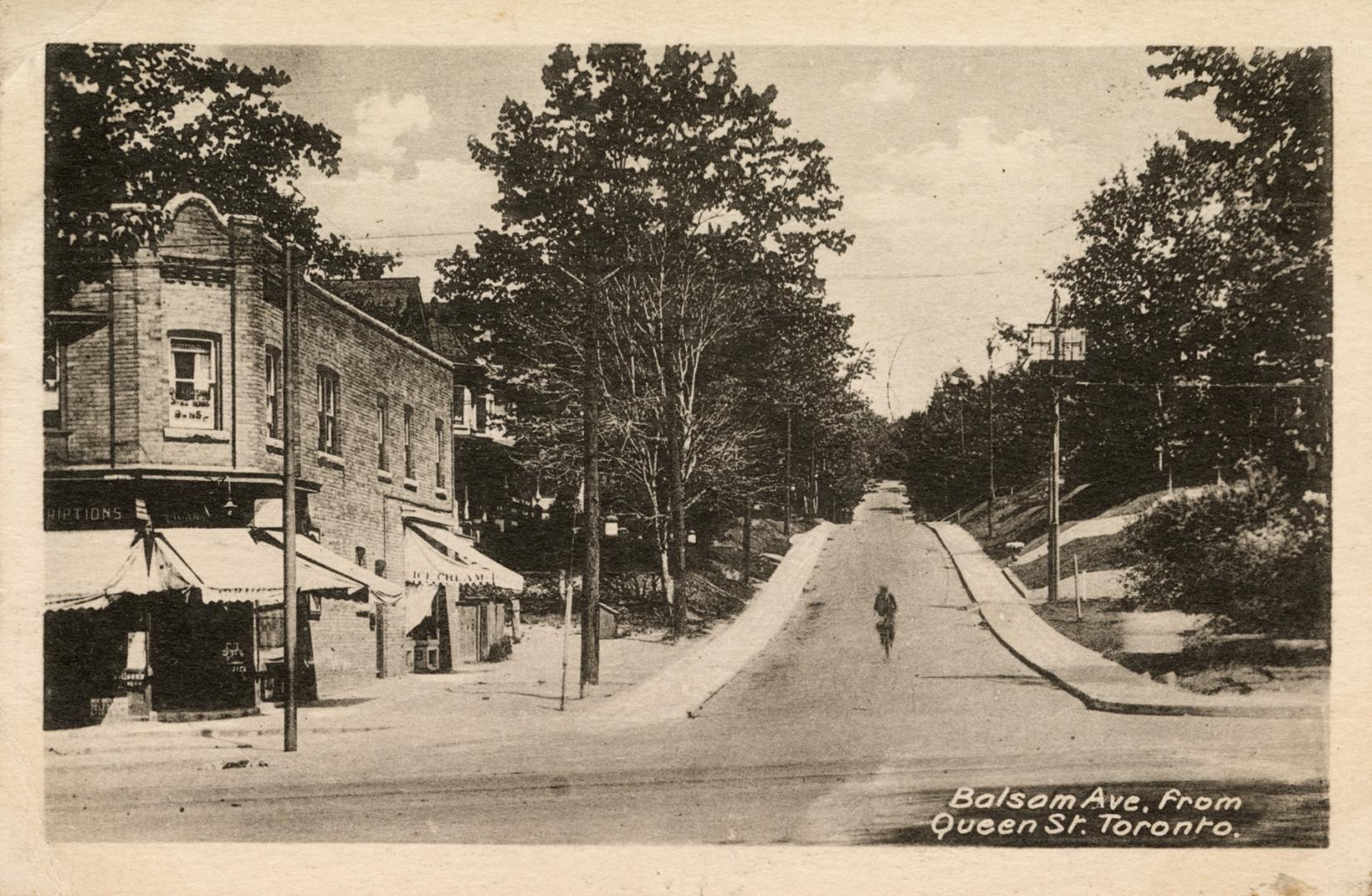Picture of street going up a hill with building on left. 