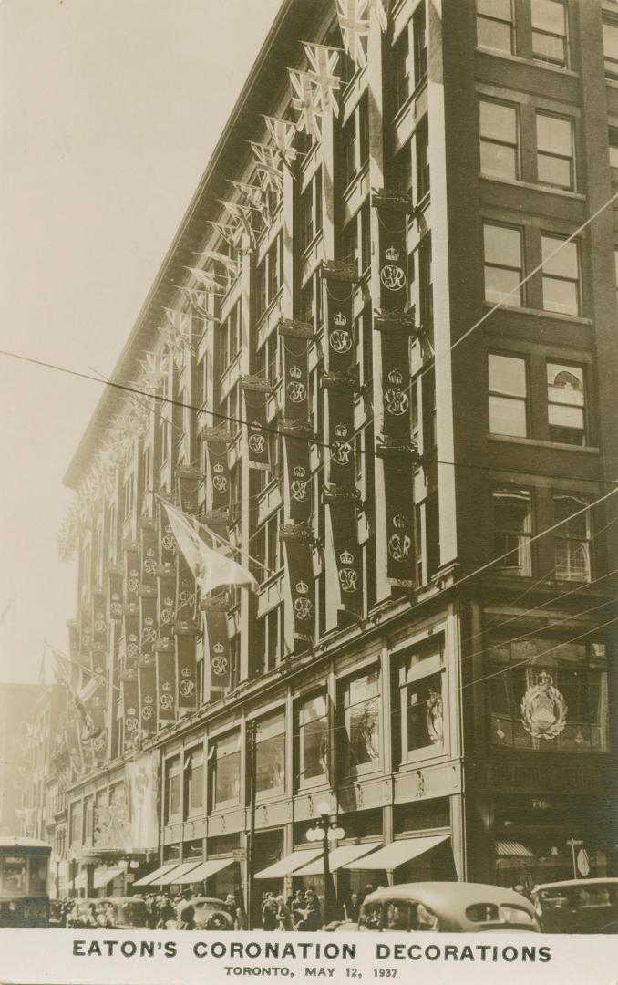 Picture of building decorated with coronation flags and banners.