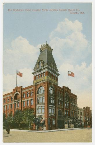 Colorized photograph of a three story hotel building with a tower.
