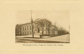 Picture of a large library building on street corner with wide cream coloured border. 