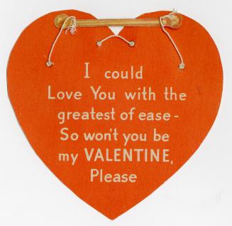 A red heart shaped card with a rhyming verse at the centre. Attached to the card with string is ...