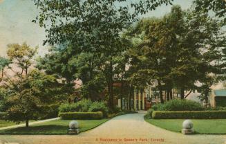 Picture of a large house hidden behind large trees. 
