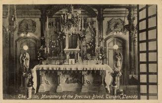 Black and white photograph of a church altar surrounded by statuary.