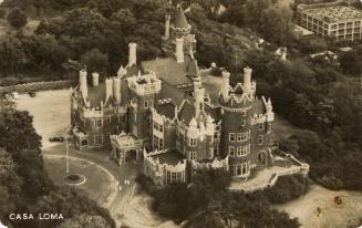 Black and white aerial photograph of a castle with turrets.