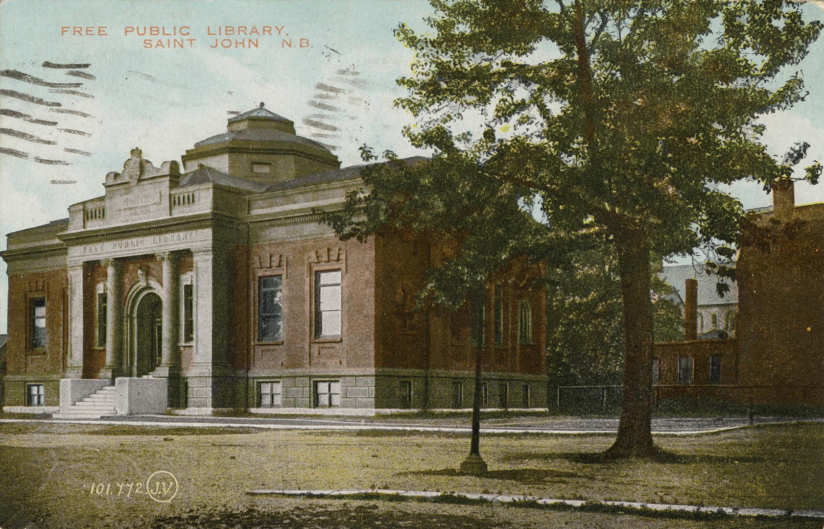 Picture of large public library with front pillars and dome on the roof and large tree to the r ...