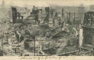 Black and white photo postcard depicting an elevated view of the area of Toronto damaged by the ...