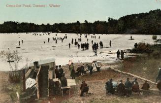 Colorized photograph of many people walking on a frozen pond with people sitting on the shoreli ...