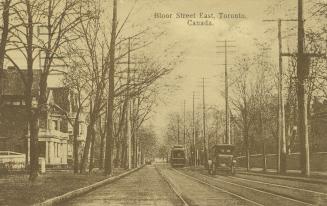 Sepia toned photograph of a streetcar and an automobile running along a city street with large  ...