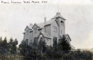 Black and white photograph of a two story school building with a turret. 