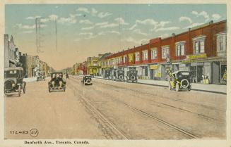 Colorized photograph of a city street with ten automobiles.